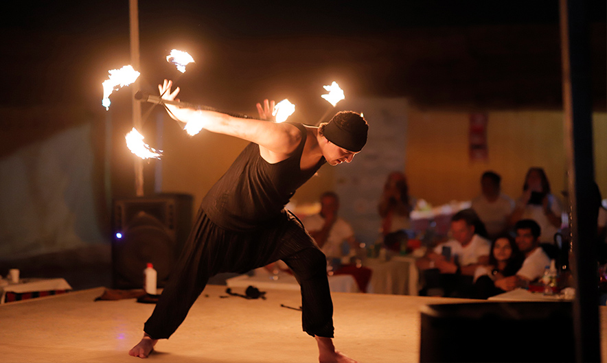 Guests enjoying camel ride at Dubai desert camp